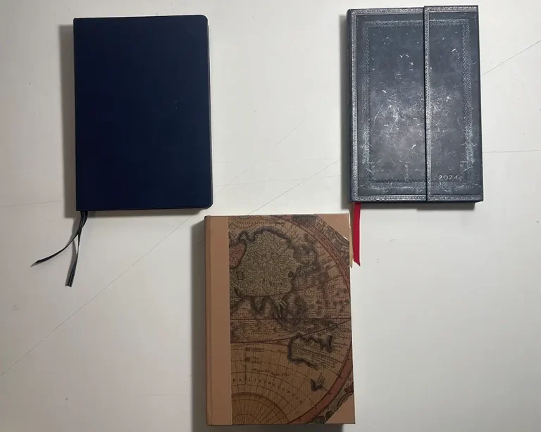 Un taccuino Leuchtturm1917 che uso come diario, un'agenda Paperblanks e un taccuino rilegato a mano